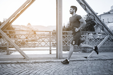 Image showing man jogging across the bridge at sunny morning