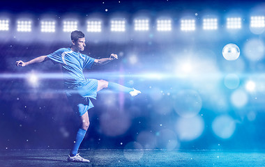 Image showing soccer player in front of big modern stadium with flares and lig