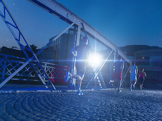 Image showing young people jogging across the bridge