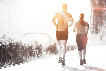 Image showing young couple jogging  in the city