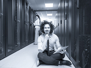 Image showing young technicians working together on servers