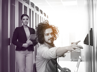 Image showing Team of young technicians working together on servers