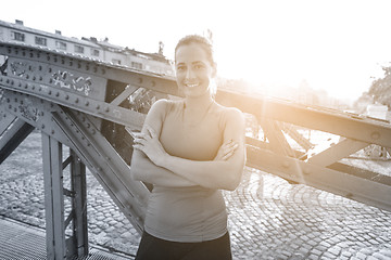 Image showing portrait of a jogging woman at sunny morning