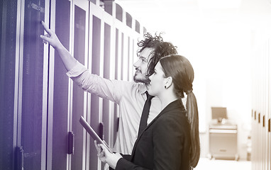 Image showing engineer showing working data center server room to female chief