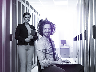 Image showing Team of young technicians working together on servers