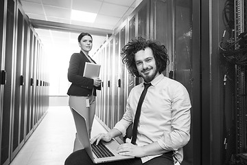 Image showing Team of young technicians working together on servers