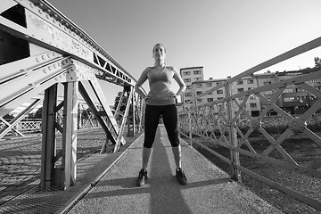 Image showing portrait of a jogging woman at sunny morning