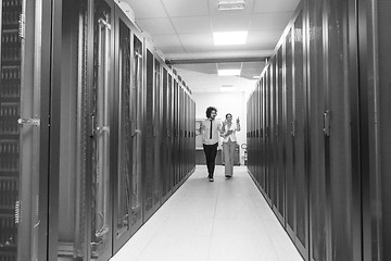 Image showing engineer showing working data center server room to female chief