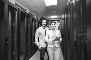 Image showing engineer showing working data center server room to female chief