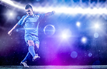 Image showing soccer player in front of big modern stadium with flares and lig