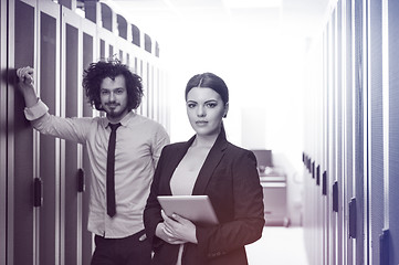 Image showing engineer showing working data center server room to female chief