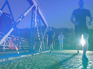 Image showing young people jogging across the bridge