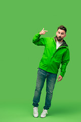 Image showing handsome bearded young man isolated on green