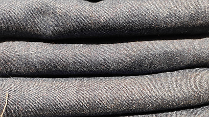 Image showing Close up of stack of blue jeans