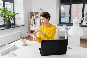 Image showing businesswoman using smart speaker at office