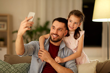 Image showing father and daughter taking selfie at home