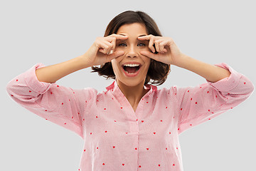 Image showing happy young woman in pajama opening her eyes