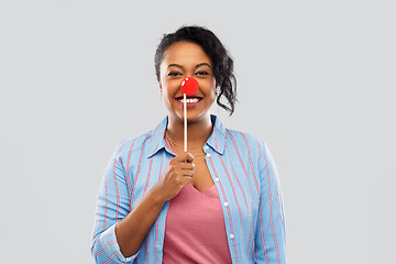 Image showing happy african american woman with red clown nose