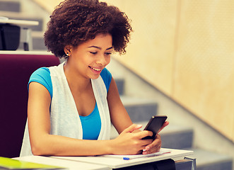 Image showing african student girl with smartphone on lecture