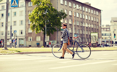 Image showing young man with fixed gear bicycle on crosswalk