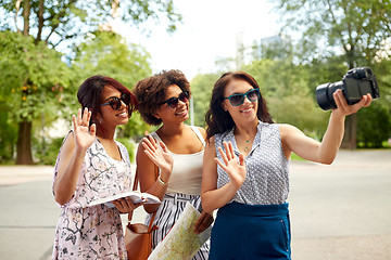 Image showing women with map travelling and recording video blog