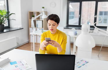 Image showing ui designer using smartphone at office