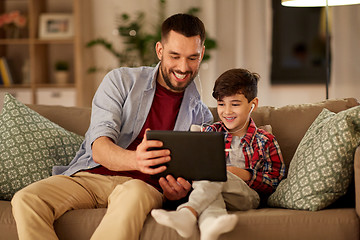 Image showing father and son listening to music on tablet pc