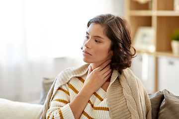 Image showing unhappy sick woman with sore throat at home