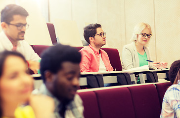 Image showing group of students with notebooks in lecture hall