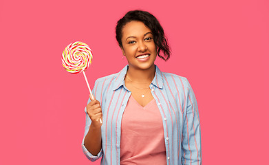 Image showing happy african american woman with big lollipop