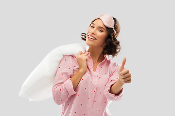 Image showing woman with pillow in pajama showing thumbs up