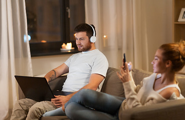 Image showing couple with laptop and smartphone resting at home