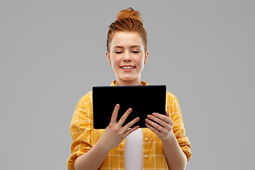 Image showing red haired teenage girl using tablet computer