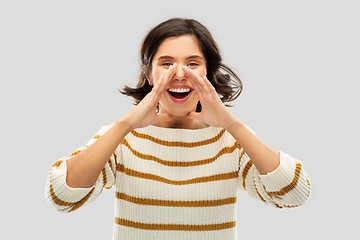 Image showing happy woman in striped pullover calling someone