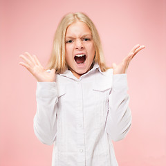 Image showing Isolated on pink young casual teen girl shouting at studio