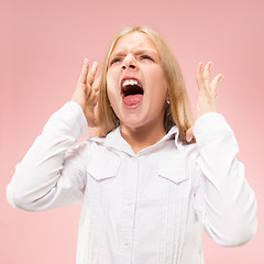 Image showing Isolated on pink young casual teen girl shouting at studio