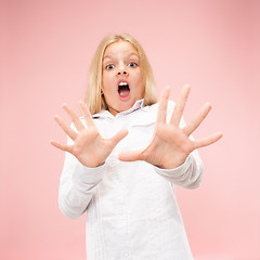 Image showing Portrait of the scared girl on pink