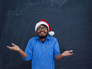 Image showing Indian man wearing traditional Santa Claus hat