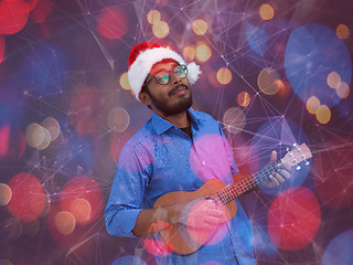 Image showing Santa playing Latin America traditional small guitar