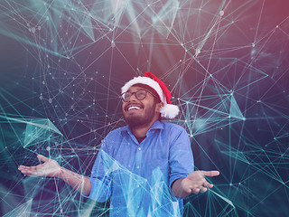 Image showing Indian man wearing traditional Santa Claus hat and ai gues his n