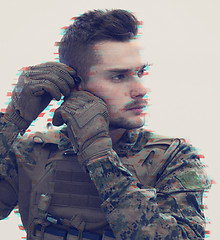 Image showing soldier preparing gear for action glitch effect