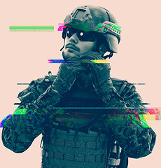 Image showing soldier preparing gear for action glitch effect