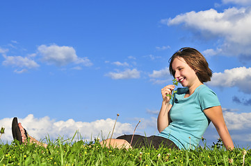 Image showing Young girl sitting on grass