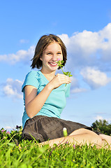 Image showing Young girl sitting on grass