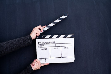 Image showing movie clapper on black chalkboard background