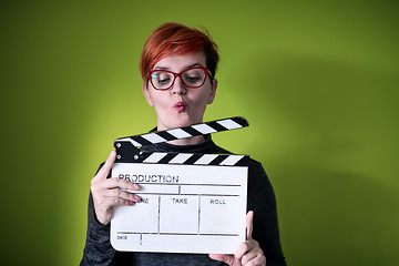 Image showing woman holding movie clapper against green background