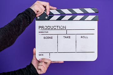 Image showing movie clapper on purple violet background