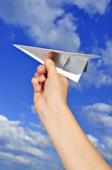 Image showing Hand holding paper airplane