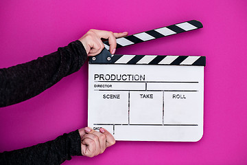 Image showing movie clapper on pink purple violet background