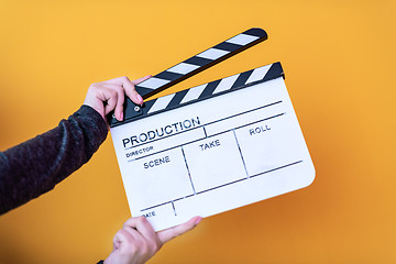 Image showing movie clapper isolated on yellow background